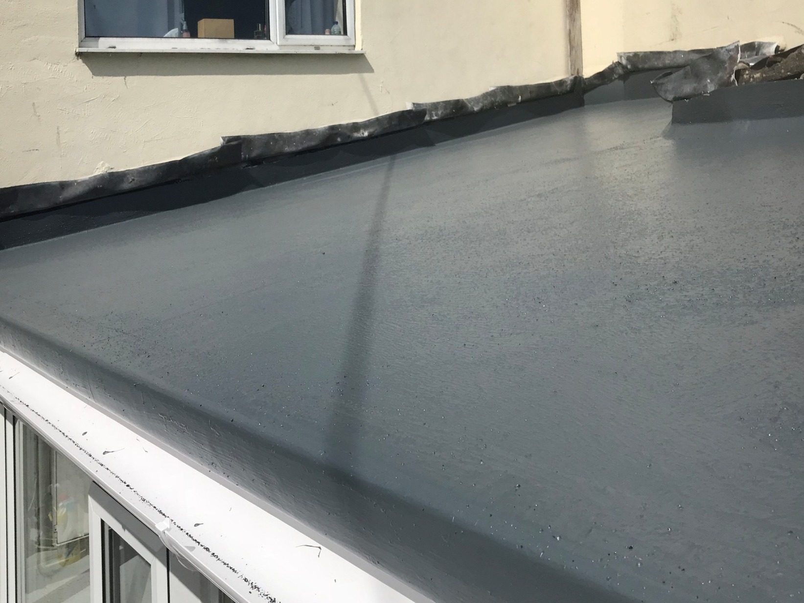 GRP fiberglass roof top coated with gel and non slip grit, ready for the lead flashings to be redressed. 