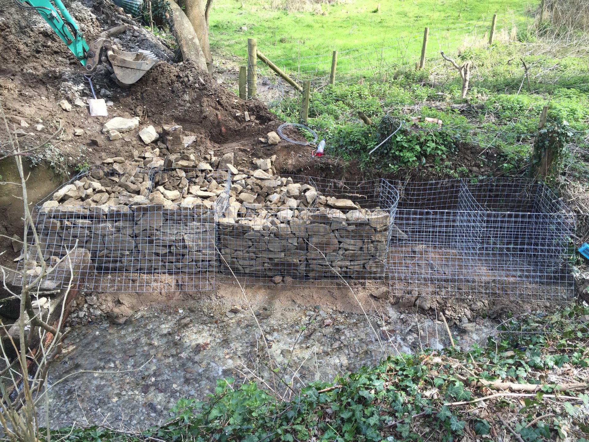 Gabion baskets were installed on solid rock base and back filled with stone and topped with soil North Devon 