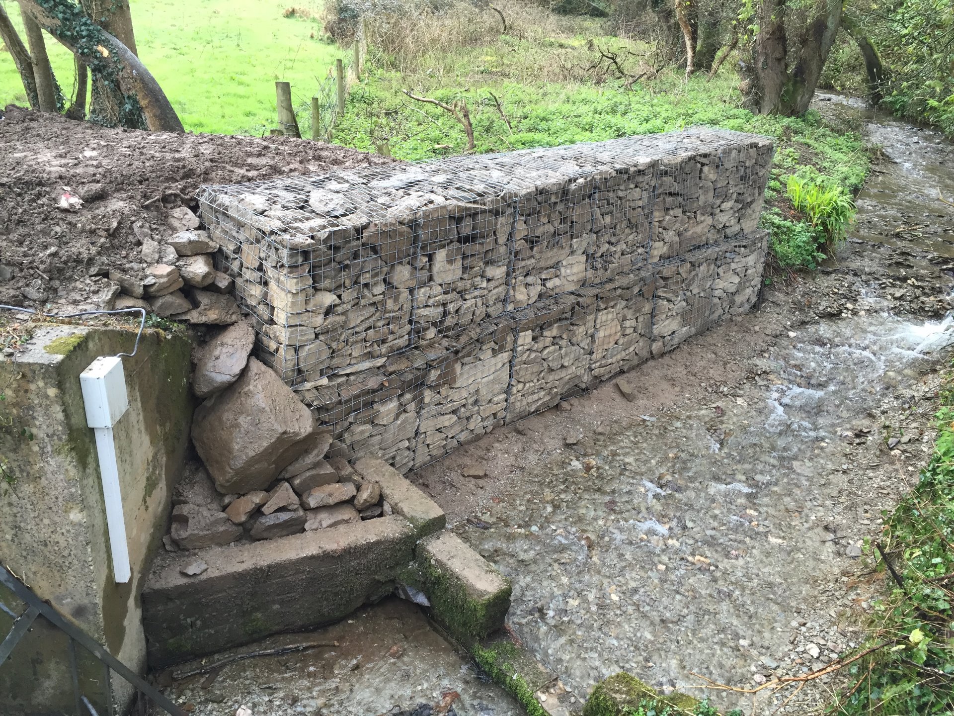Two layers of gabion baskets were installed and back filled, this was to divert the water from its natural course, to avoid potential flooding of a North Devon Factory, built by MJS Building Maintenance Ltd.