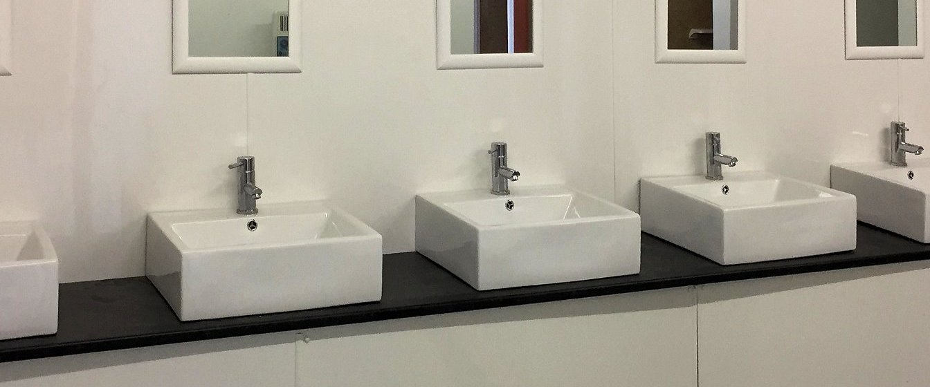 Camp site shower block with belfast sinks in bathroom installations