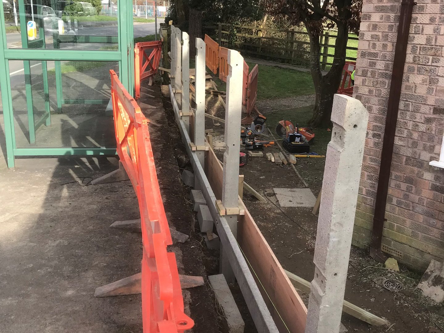 Concrete fence posts installed and spaced off of the shuttering ready to be set into the ring beam.