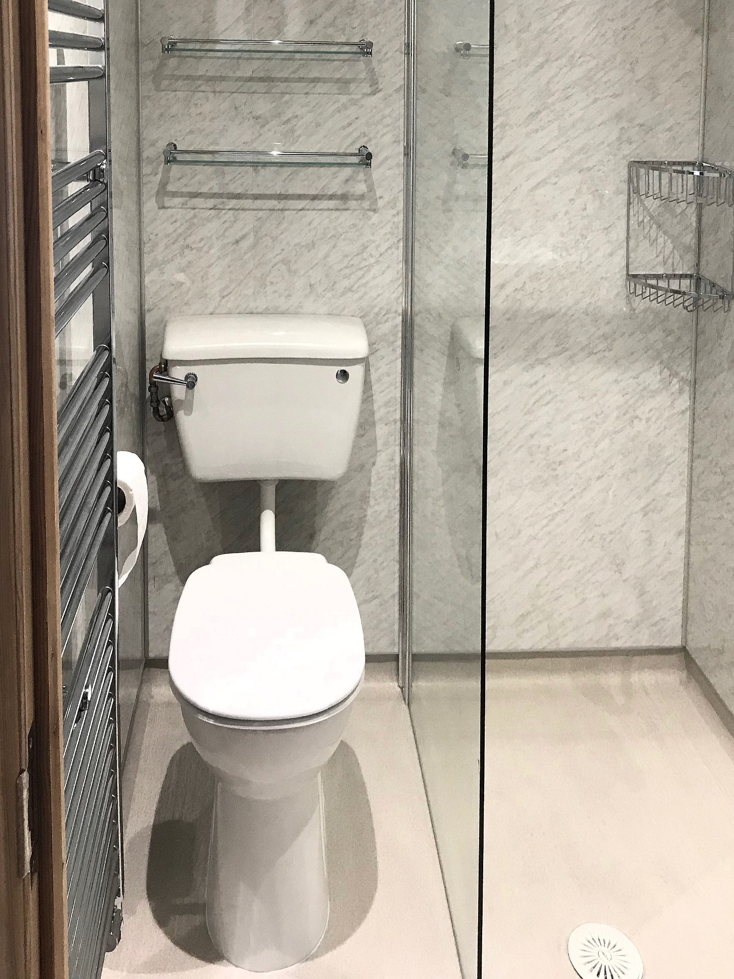 High level WC pan with low level cistern installed. High level glass shelves fitted with chrome retaining rail. Barnstaple North Devon