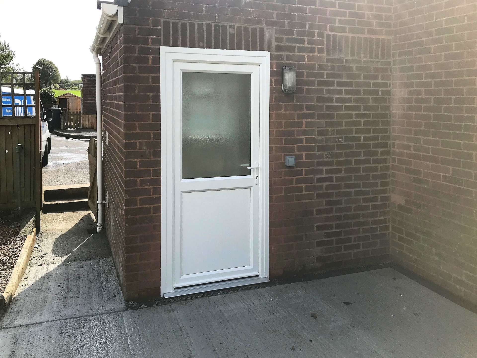 A new uPVC wide rear door in new position to access level outside disabled friendly space. North Devon