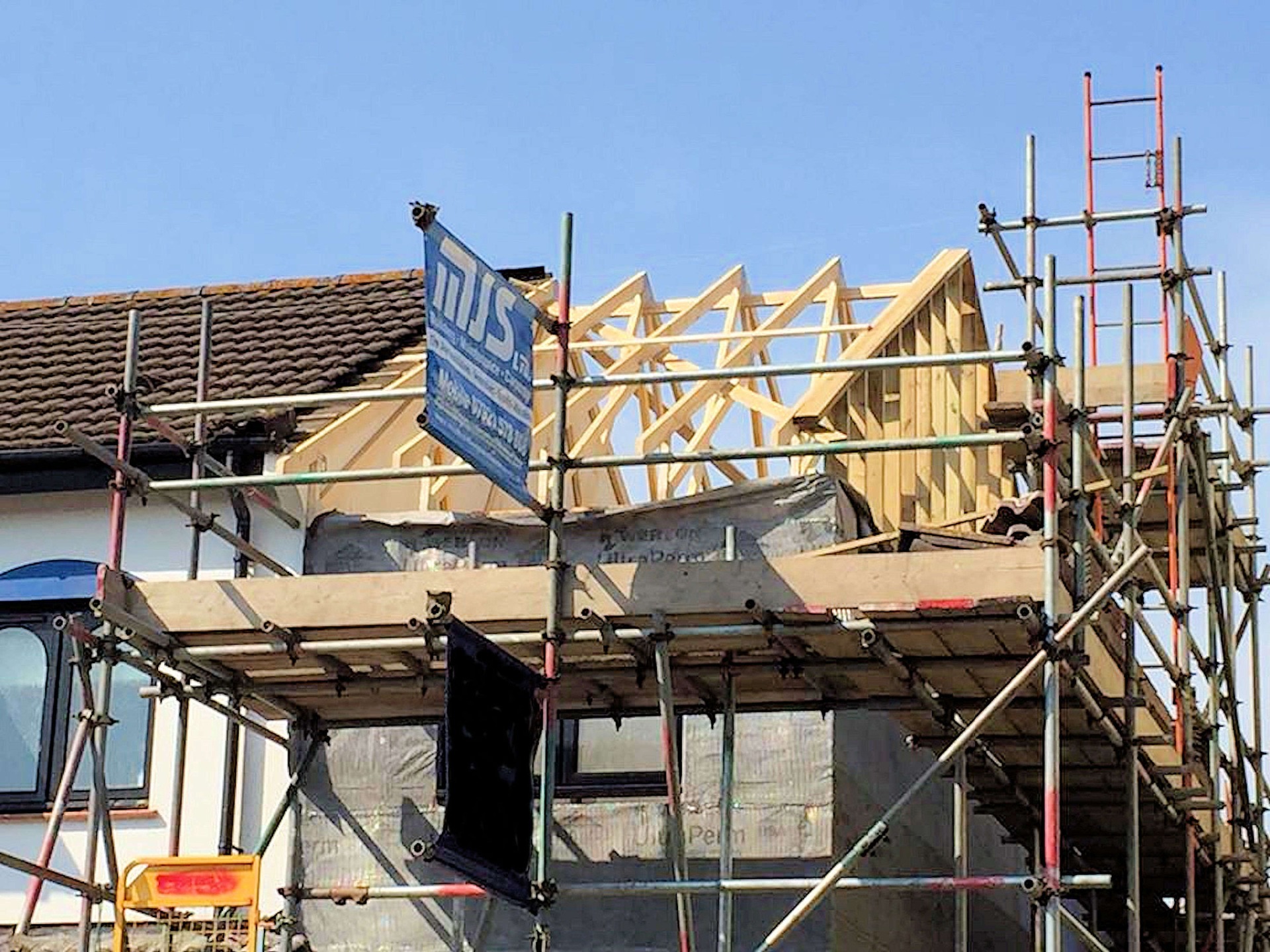 Installation of new timber roof trusses with internal wind bracing. Roof was covered with membrane and baton, ready to receive original tiles, part of house extension in Barnstaple North Devon